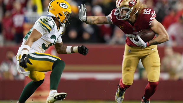 Jonathan Owens closes in for a tackle of George  Kittle in the playoffs.